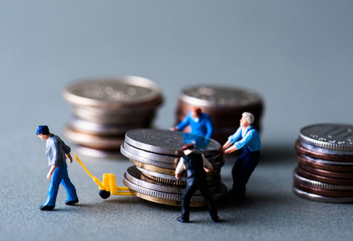 A miniature people pushing a coins- Payroll Tax Relief - ERTC
